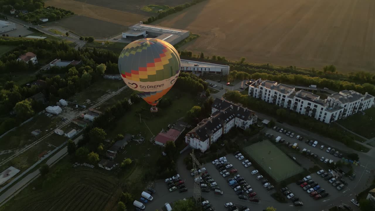 Hot air balloon floats over Szczecin, Poland at golden hour with scenic views of buildings and greenery