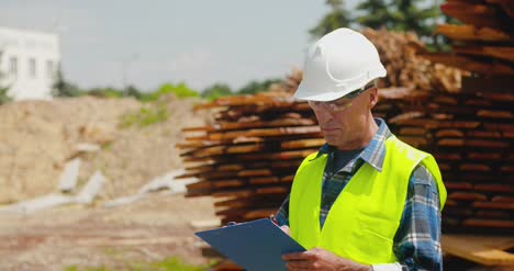 male worker examining plank's stack 2