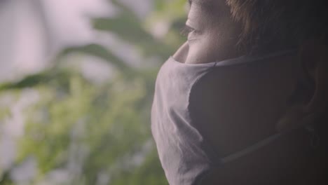 asian man in face mask admiring the beauty of cloud forest in singapore during pandemic. - close up