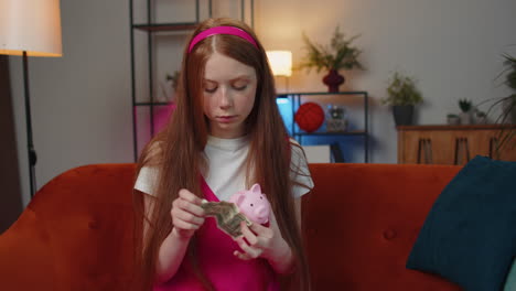 poor child girl kid holding piggybank and one dollar banknote, financial crisis, bankruptcy, poverty