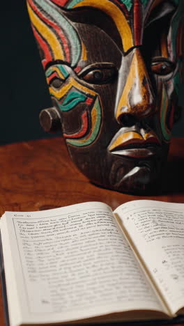 tribal mask and open book
