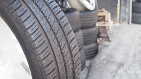 close-up of a car tire and stacked tires