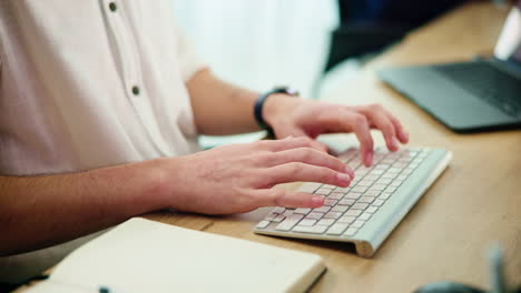 man sitting at desk working on laptop