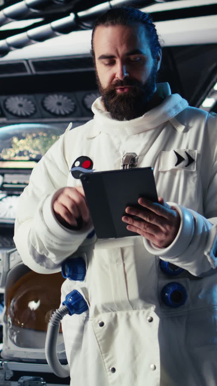 Vertical video Portrait of joyful astronaut holding helmet in starship