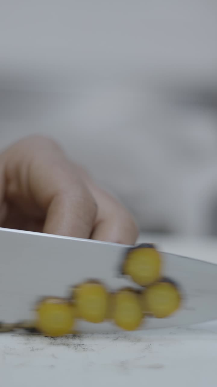 Close-up of Hand Slicing Carrots with a Knife