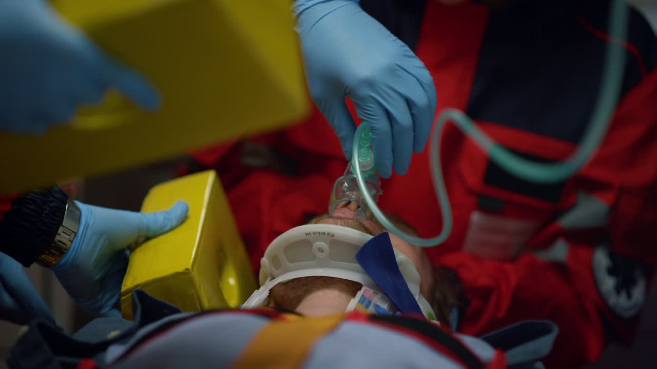 EMS paramedics providing first aid help to injured man