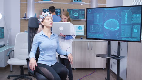 Neuro-science-female-doctor-and-her-assistant-in-modern-facility