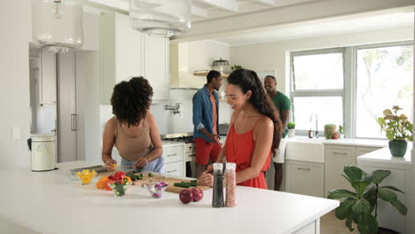 diverse friends preparing fresh vegetables in modern kitchen, enjoying cooking together, at home