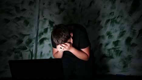 Cyberbullying-Concept,-Teenager-Reading-Offensive-Messages-on-Laptop-and-Cover-His-Face