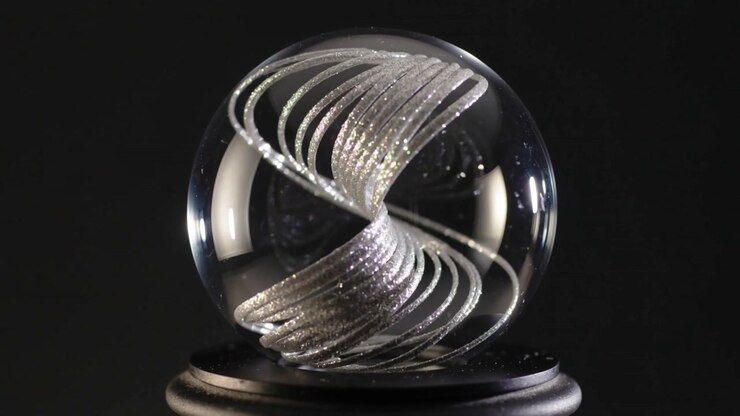 Abstract Silver Spiral Sculpture Inside a Glass Sphere