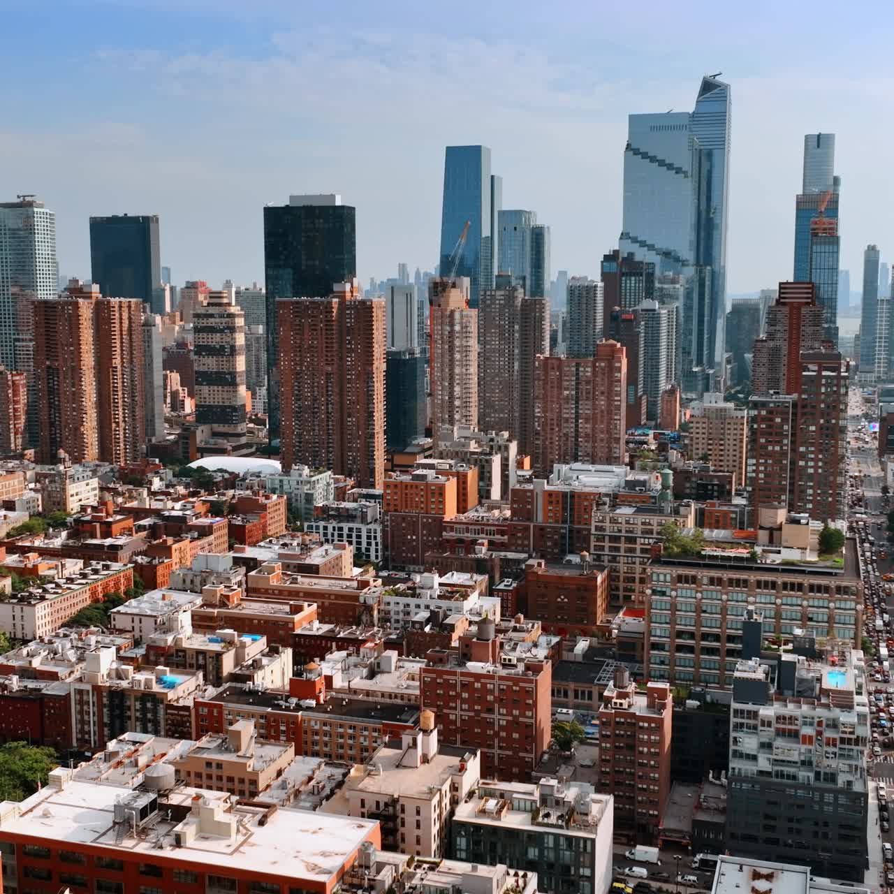 Usual building contrasting with gorgeous skyscrapers. Drone flight above New York on sunny day