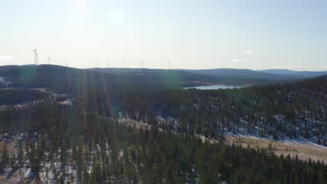 The Mighty Windmills Of Osen, Norway Under A Bright Blue Sky And Clouds Located By Fields Of Trees - Aerial Shot