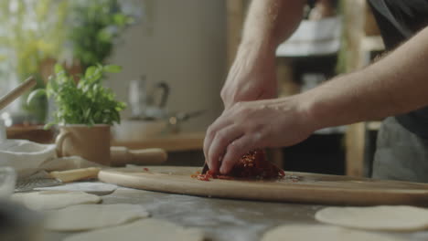 person chopping ingredients on a cutting board in a kitchen