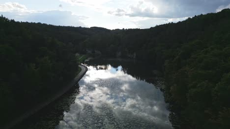 Beautifully-clear-Lake-Harasov-in-the-Kokorin-valley,-mirroring-a-sky-full-of-clouds