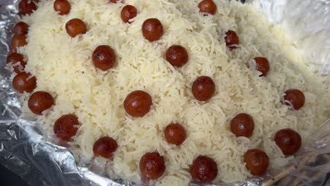 kolkata style sitabhog with small gulab jamuns on top.