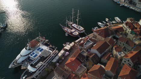 close up drone orbit shot of cruis ships and sailing vessels parked in milna port, brac island, croatia