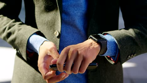 man using smartwatch and mobile phone 4k