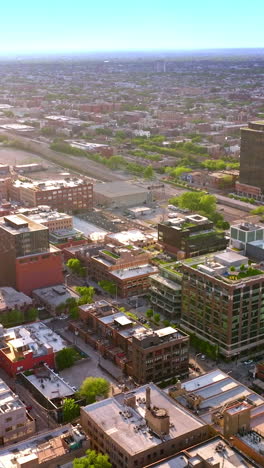 sunlit buildings in the quarters of chicago. endless cityscape of metropolis at the backdrop of blue skies. vertical video