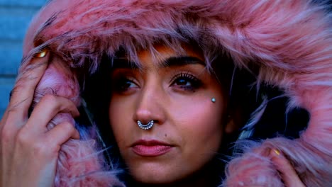 woman with nose ring and fur jacket standing outside the shop 4k