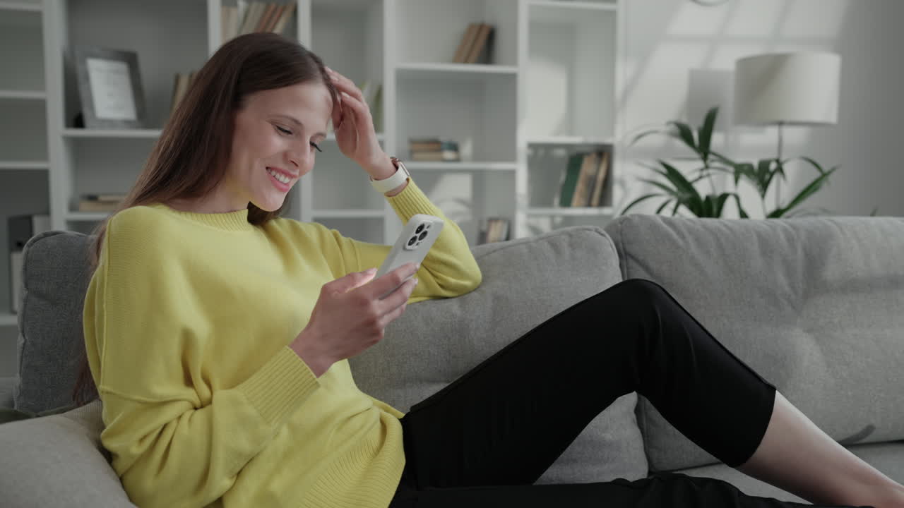 Woman relaxing on couch using her phone