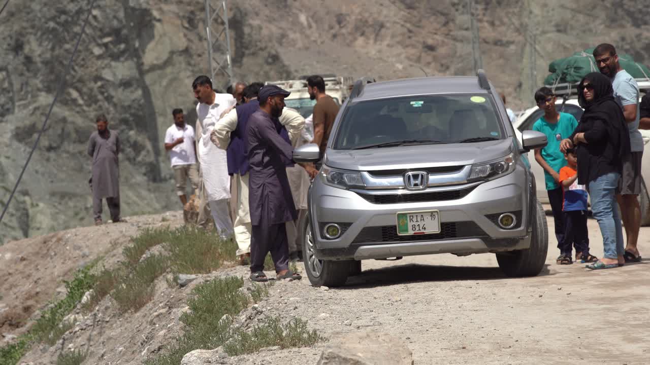 Group of People on a Road Trip in the Mountains of Pakistan