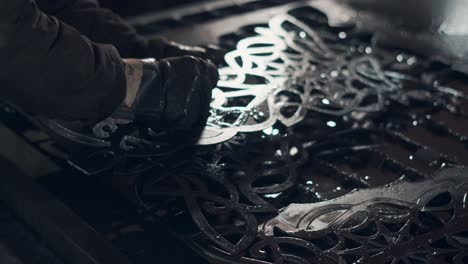 metal artist working on a decorative metal panel