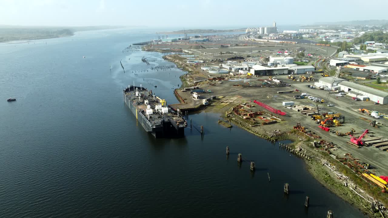 US, WA, Aberdeen, 2025-10-29 - Drone view of an a ship in an industrial area in the city in fall