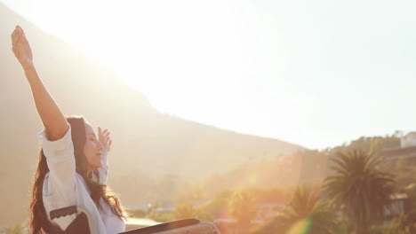 Disabled-woman-with-arms-outstretched-at-the-beach