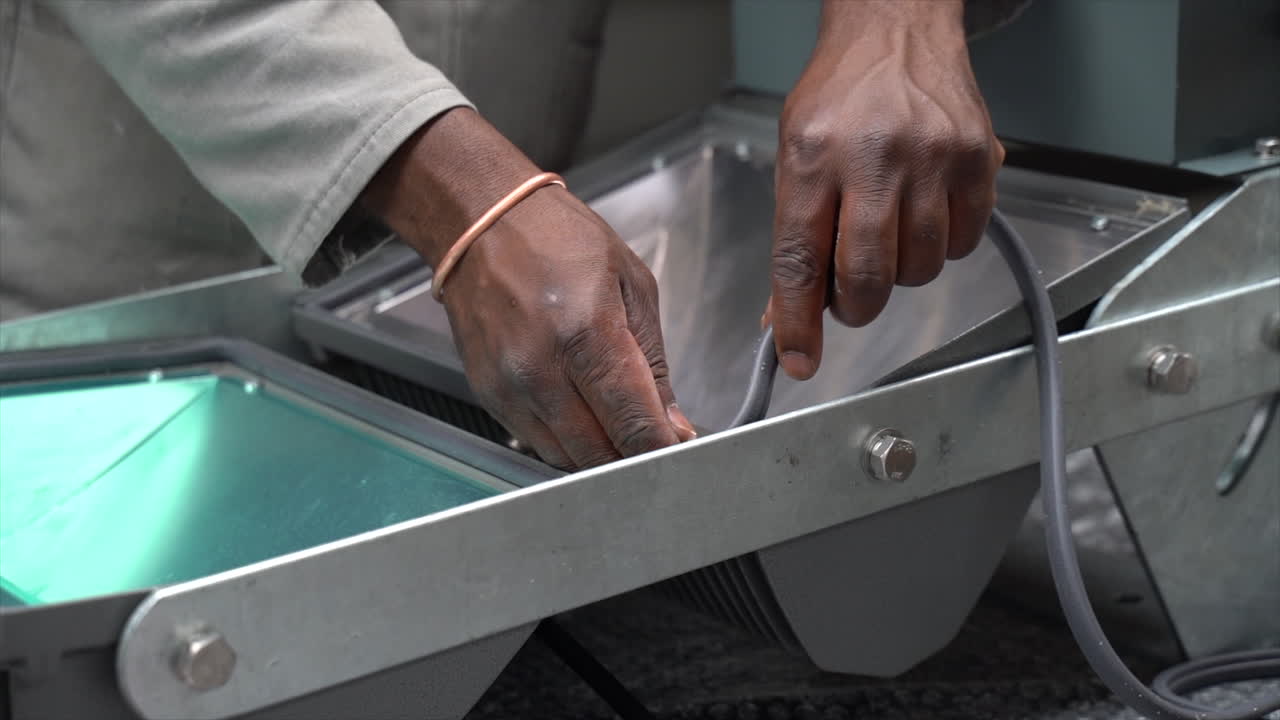 Factory worker fixing a waterproof seal to a set of led lights