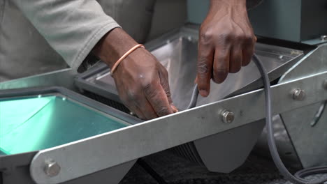 factory worker fixing a waterproof seal to a set of led lights