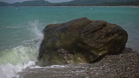 Slow-motion-shot-of-waves-crashing-on-rock-along-the-beach-of-Banbanon,-Surigao-del-Norte,-Philippines