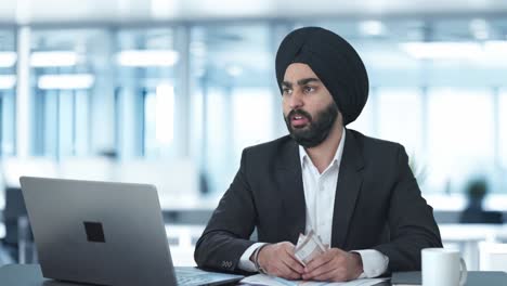 sad sikh indian businessman counting money