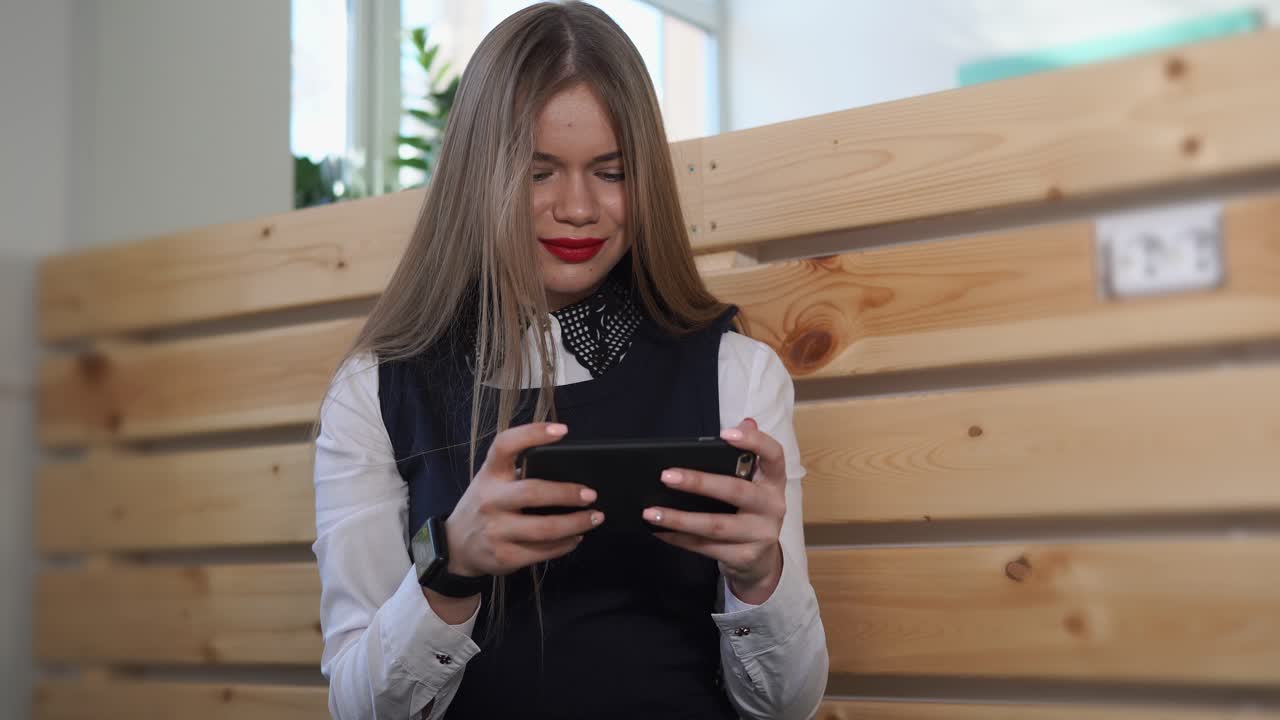 Young Woman Using Smartphone in Office