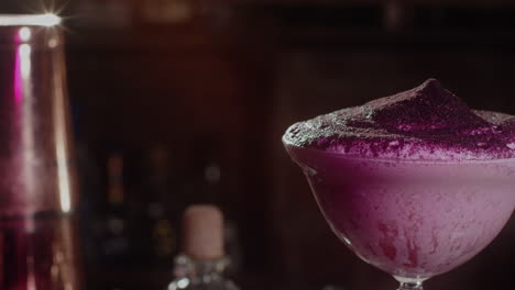 purple cocktail with foam and garnish