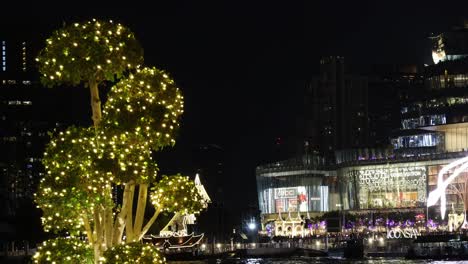 decorated trees with lights in a bustling cityscape