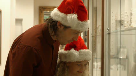 family with christmas hat shopping