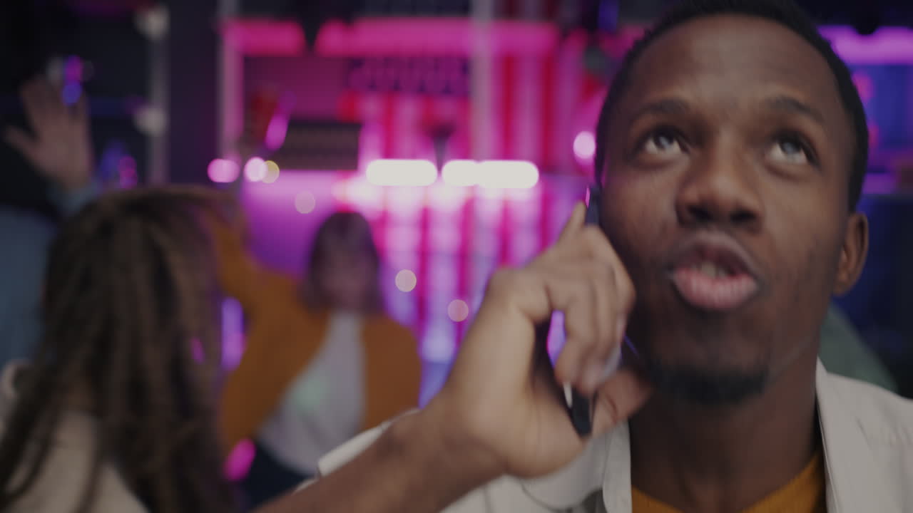 Man Talking on Phone at a Party