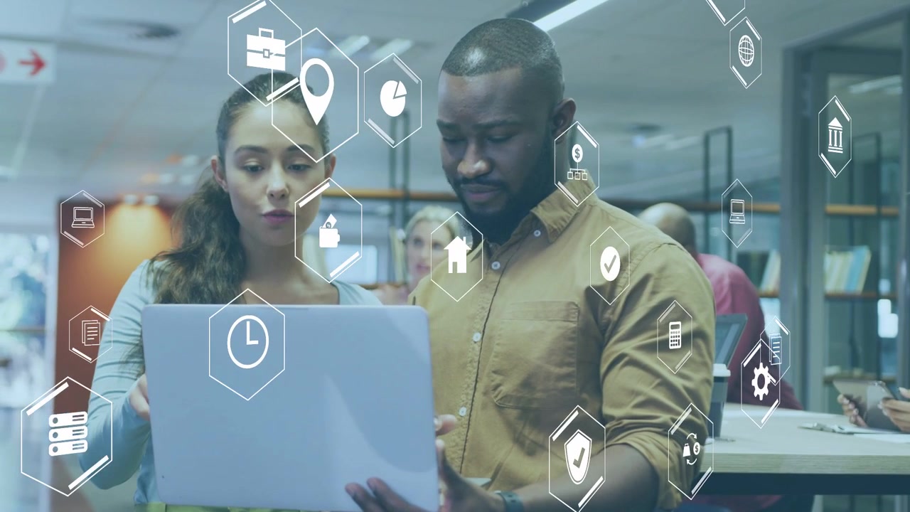 Man holding laptop open while woman pointing, reviewing content in library as hex icons animating