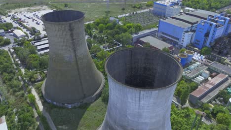 high angle aerial arc around two concrete natural draft cooling towers