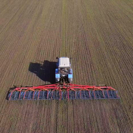 the tractor draws an agricultural device for harrowing the land 3