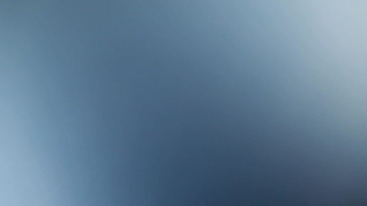 Close-up spinning white wing of huge wind turbine, isolated blue background