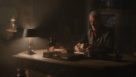 older passionate man evaluates an old porcelain box
