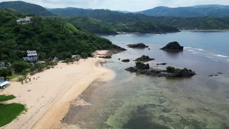 aerial view of white sandy beach in puraran, baras, catanduanes, philippines - drone shot