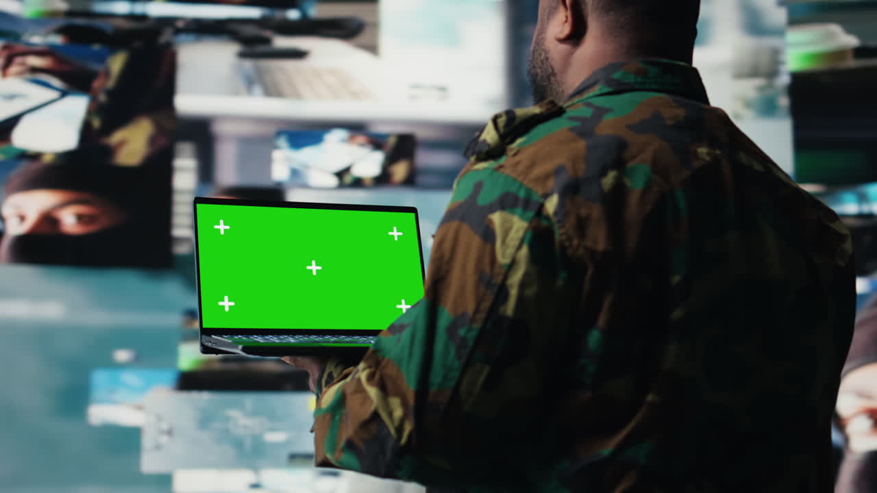 African american trooper holds laptop with copy space screen in a control tower