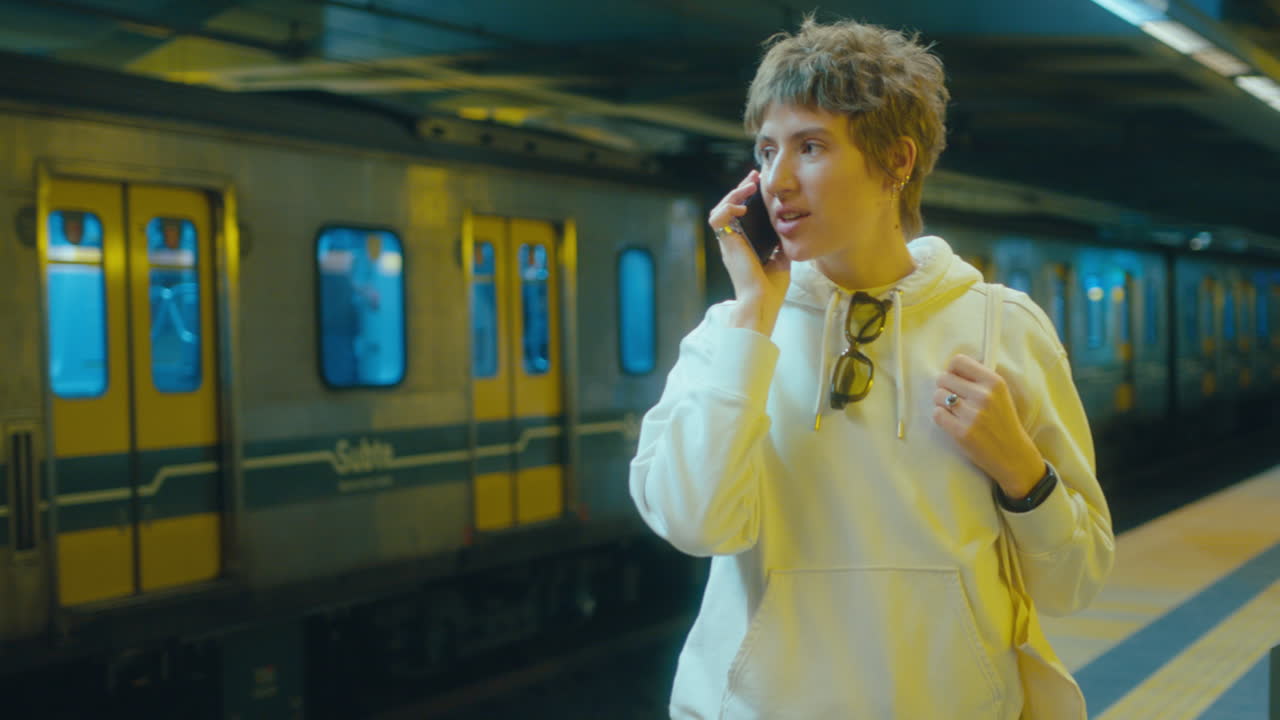 Young Woman Speaking on the Phone in Subway
