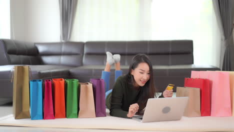 Woman-with-laptop---credit-card-shopping-online-at-home