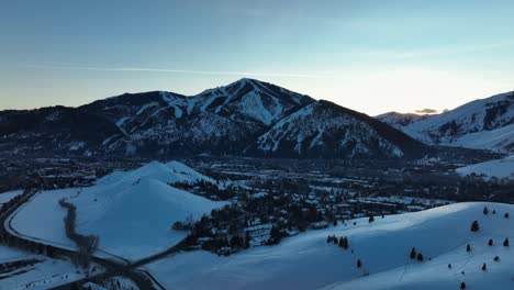 Aerial-View-Of-Snow-covered-Stanley,-Idaho,-USA-With-Majestic-Sawtooth-mountain-Range-In-Background