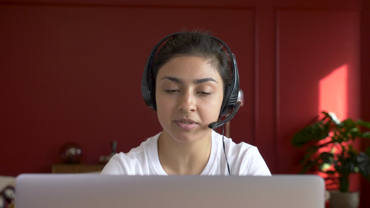 Close - up Indian female student makes conference video call on laptop ...