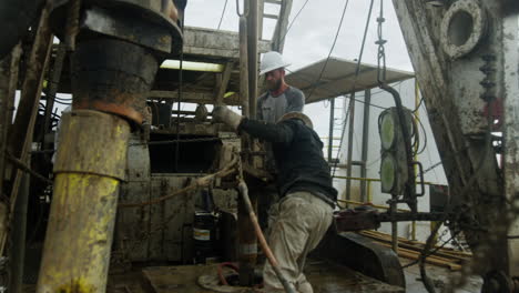 hard-working men wearing helmets set the equipment for drilling natural resources. production of oil and gas.