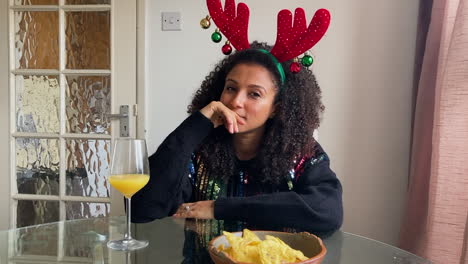 young woman on christmas video call reacting to someone opening christmas present